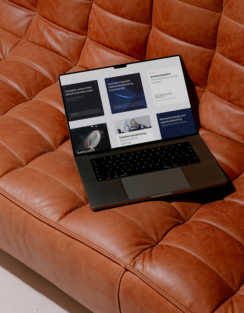 Laptop on a leather sofa showing production work
