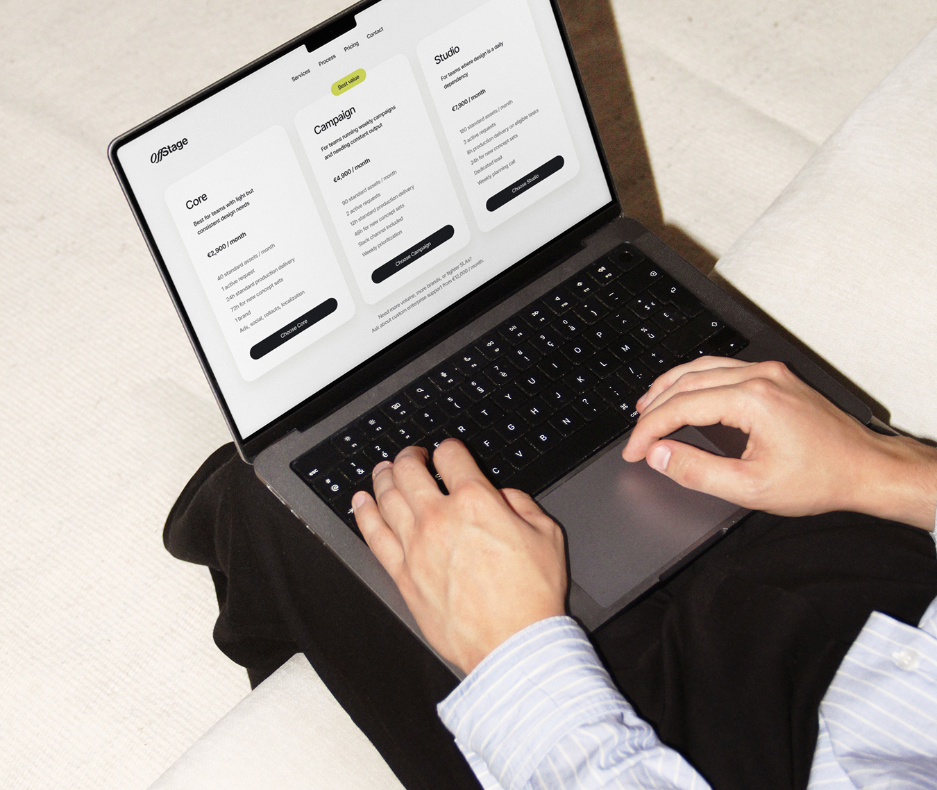 Hands using a laptop during campaign production work